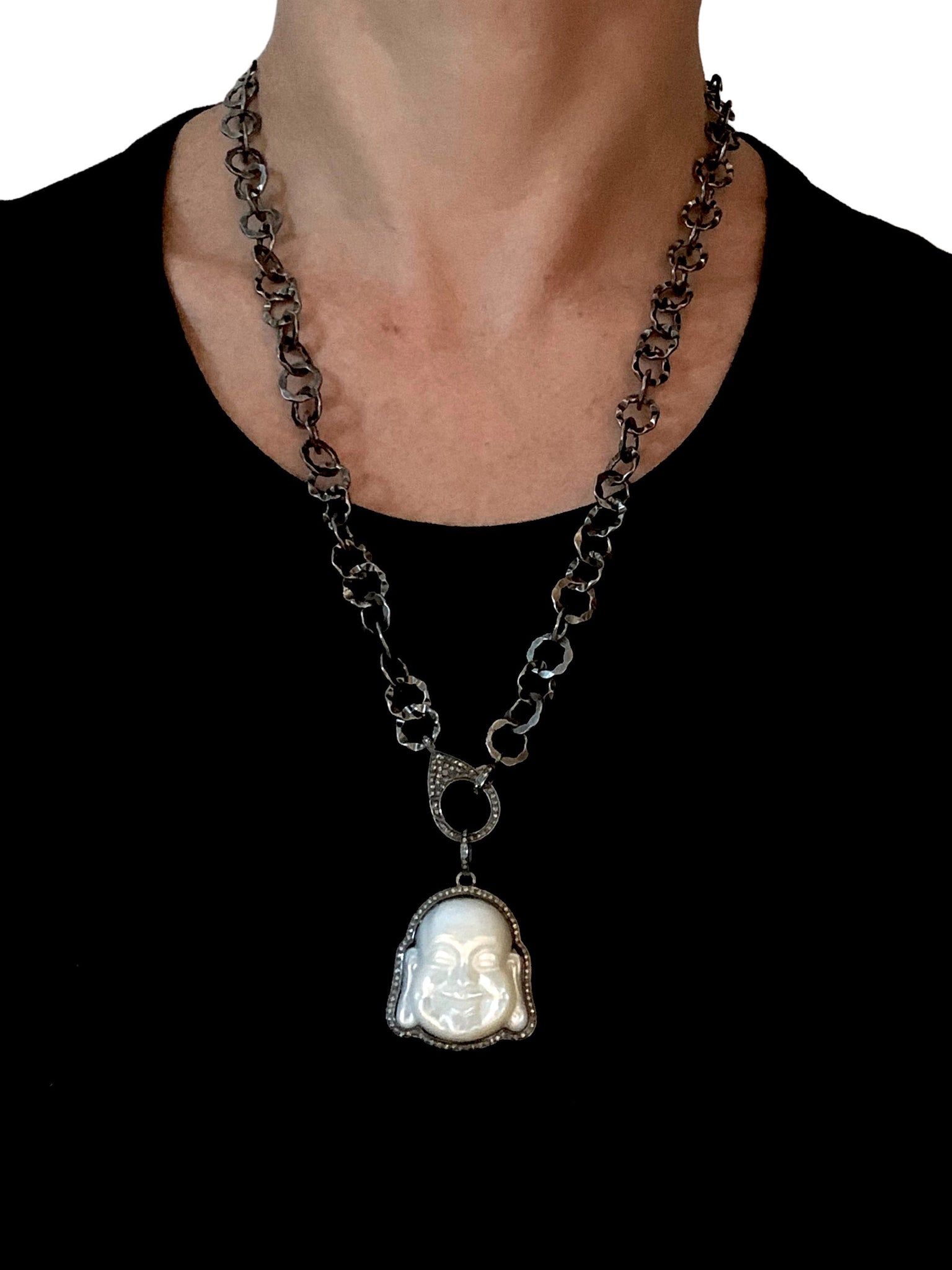 Pave Diamonds surrounding Mother of Pearl Buddha